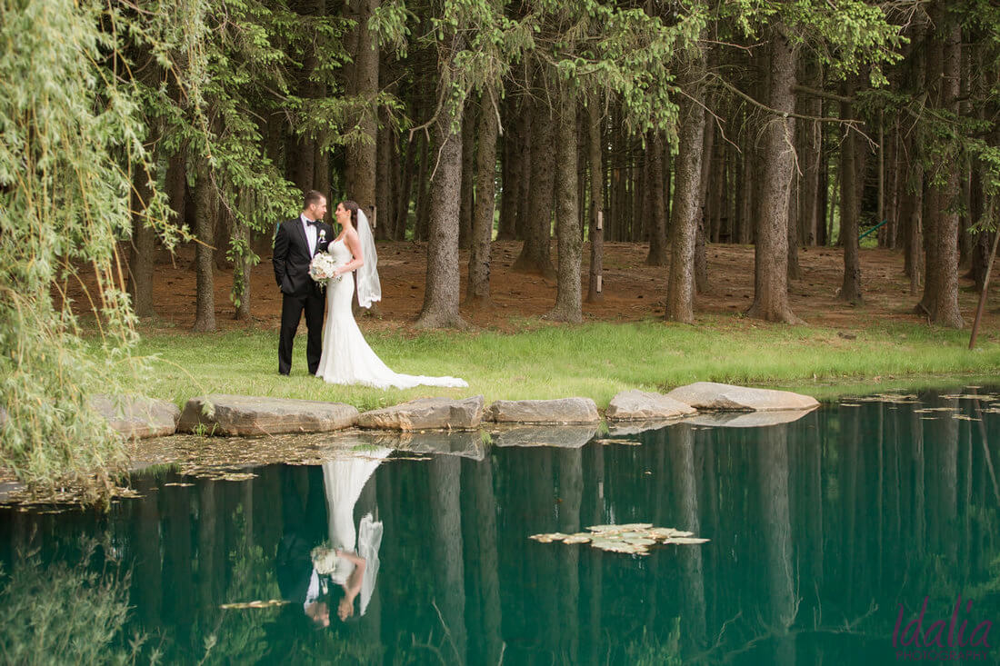 bride and groom by the forest and lake