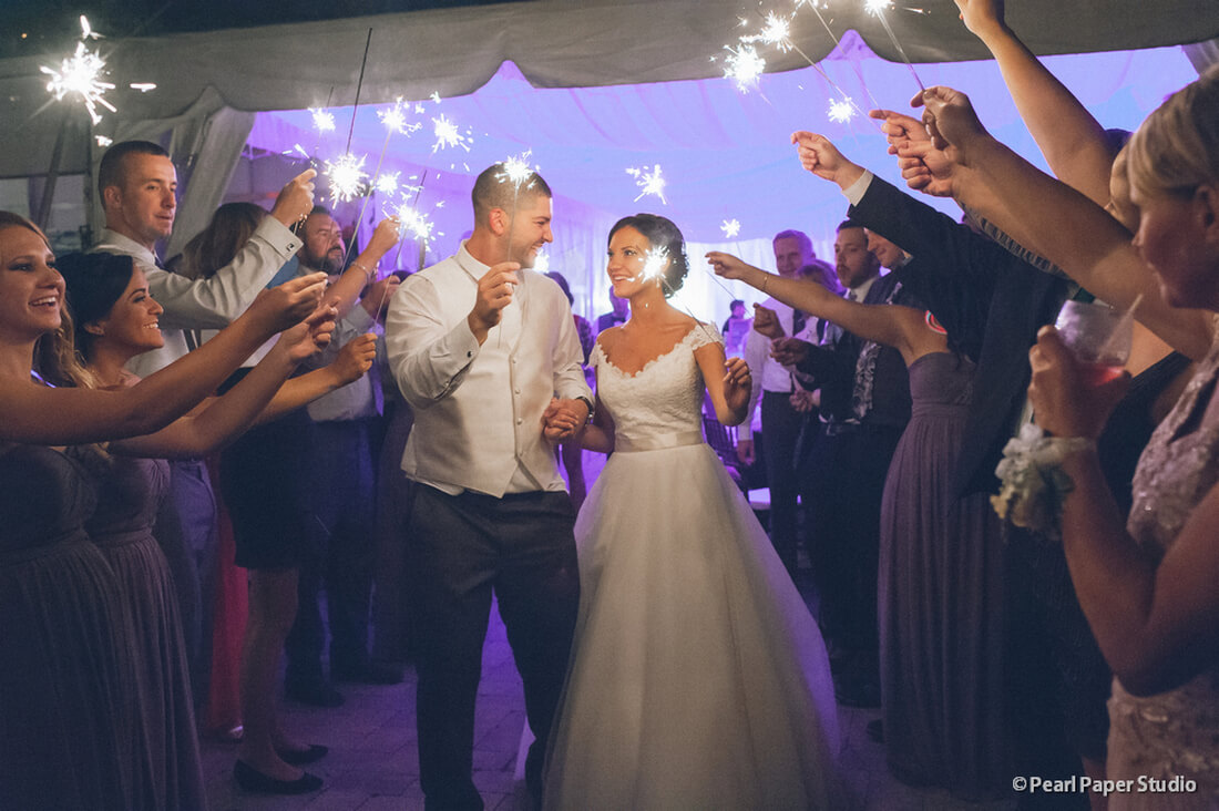 bride and groom holding sparklers