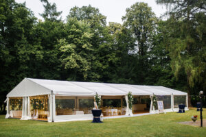 Long white tent for wedding party in the wood