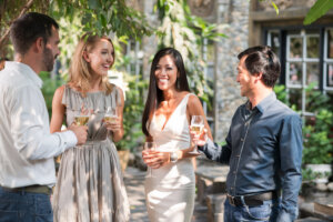 Asian couple talking to their guests at the party